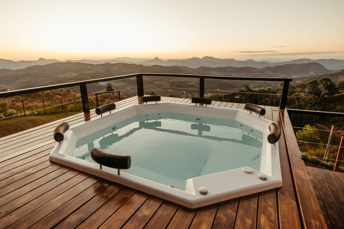 A covered hot tub on a timber deck in cool daylight
